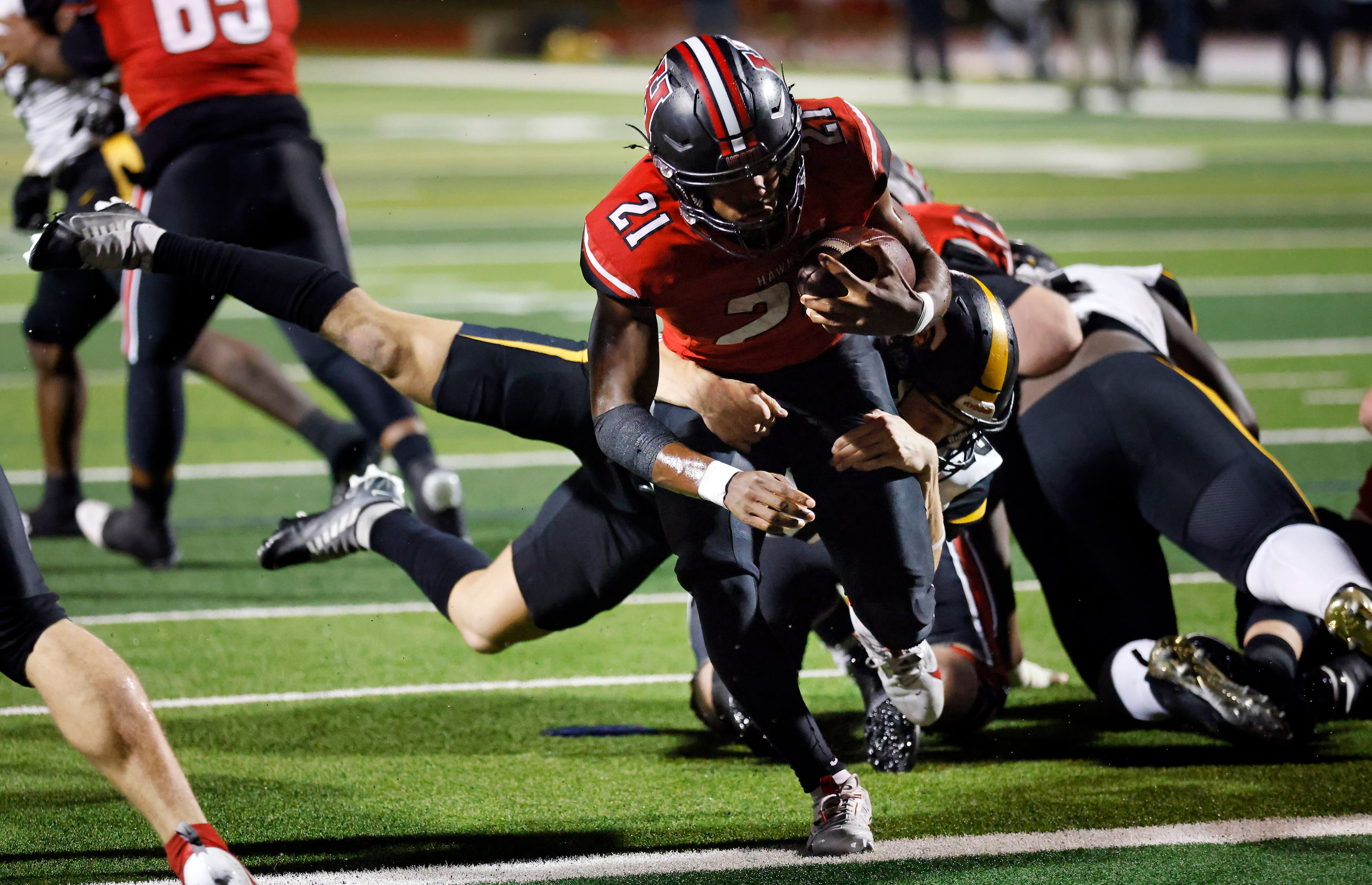 Rockwall-Heath running back Ashton Bradford (21) carries Forney linebacker Bryce Lott (30)...