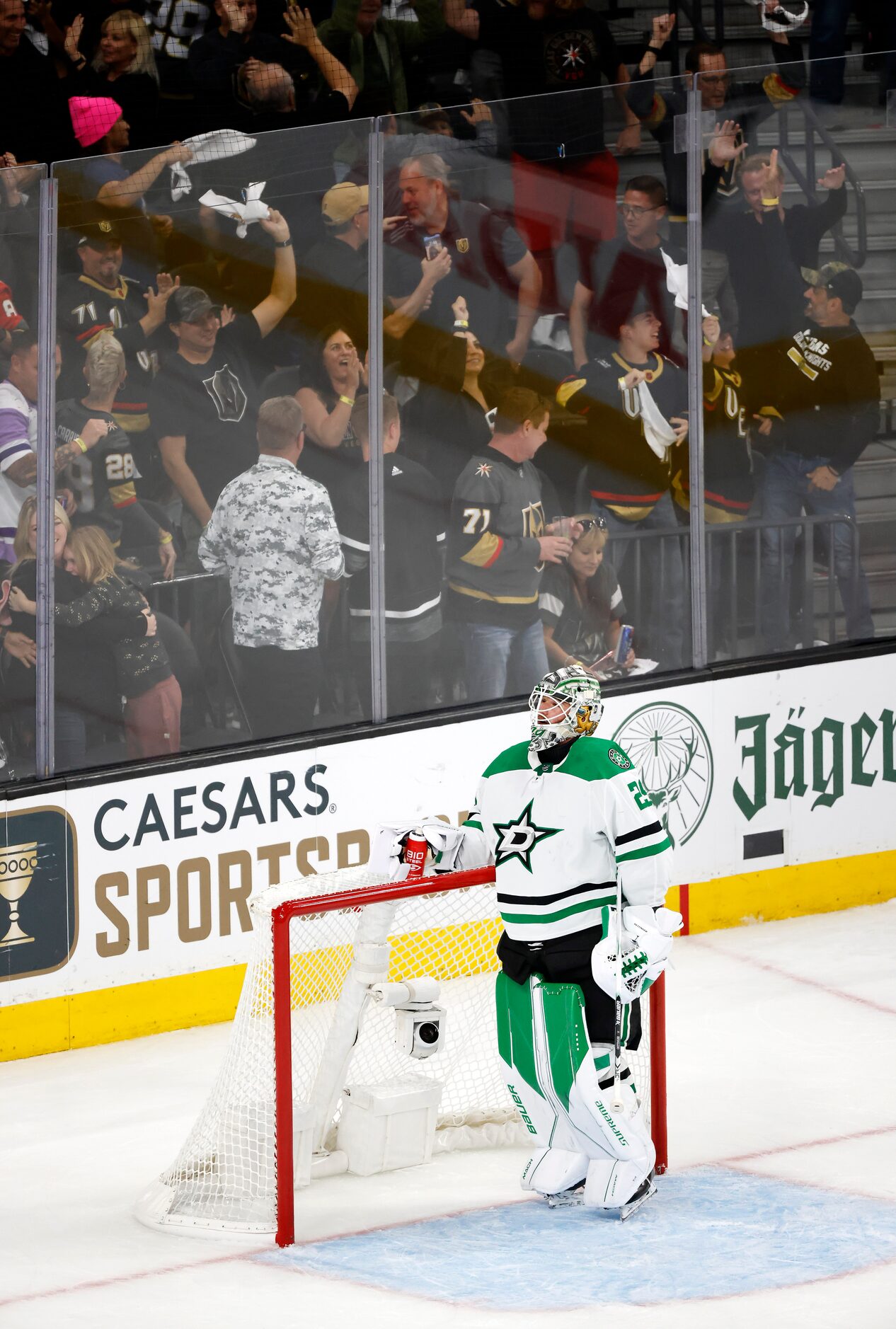 Vegas Golden Knights fans celebrate after Dallas Stars goaltender Jake Oettinger (29) was...