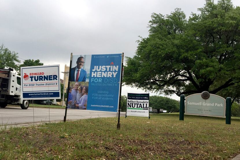 Signs for the three candidates for DISD Trustee Place 9 are seen in front of Samuell Grand...