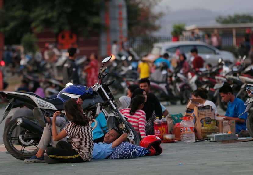 Villagers gather at a temporary shelter following earthquakes and a tsunami in Palu, Central...