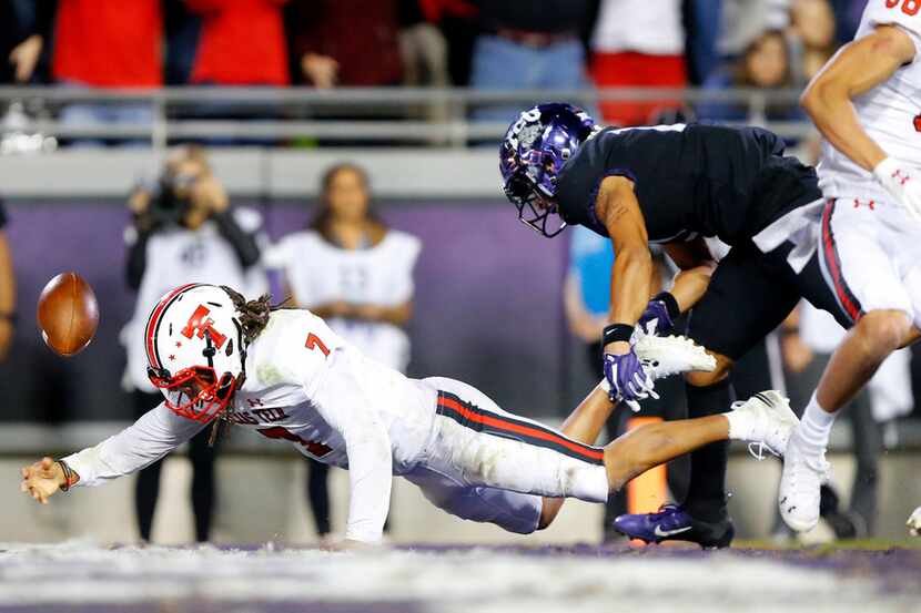Texas Tech Red Raiders quarterback Jett Duffey (7) falls into the end zone, scoring a long...