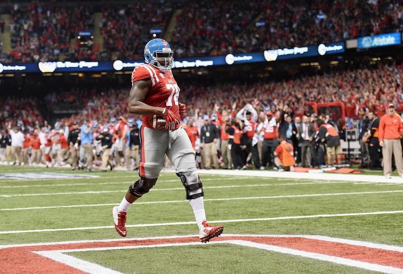 NEW ORLEANS, LA - JANUARY 01:  Laremy Tunsil #78 of the Mississippi Rebels scores runs in a...