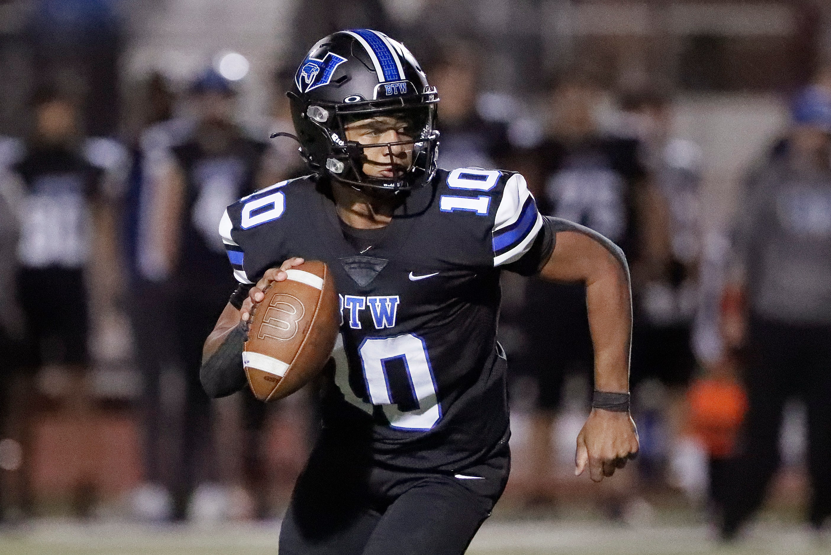 Hebron High School quarterback Patrick Crayton Jr (10) scrambles during the first half as...