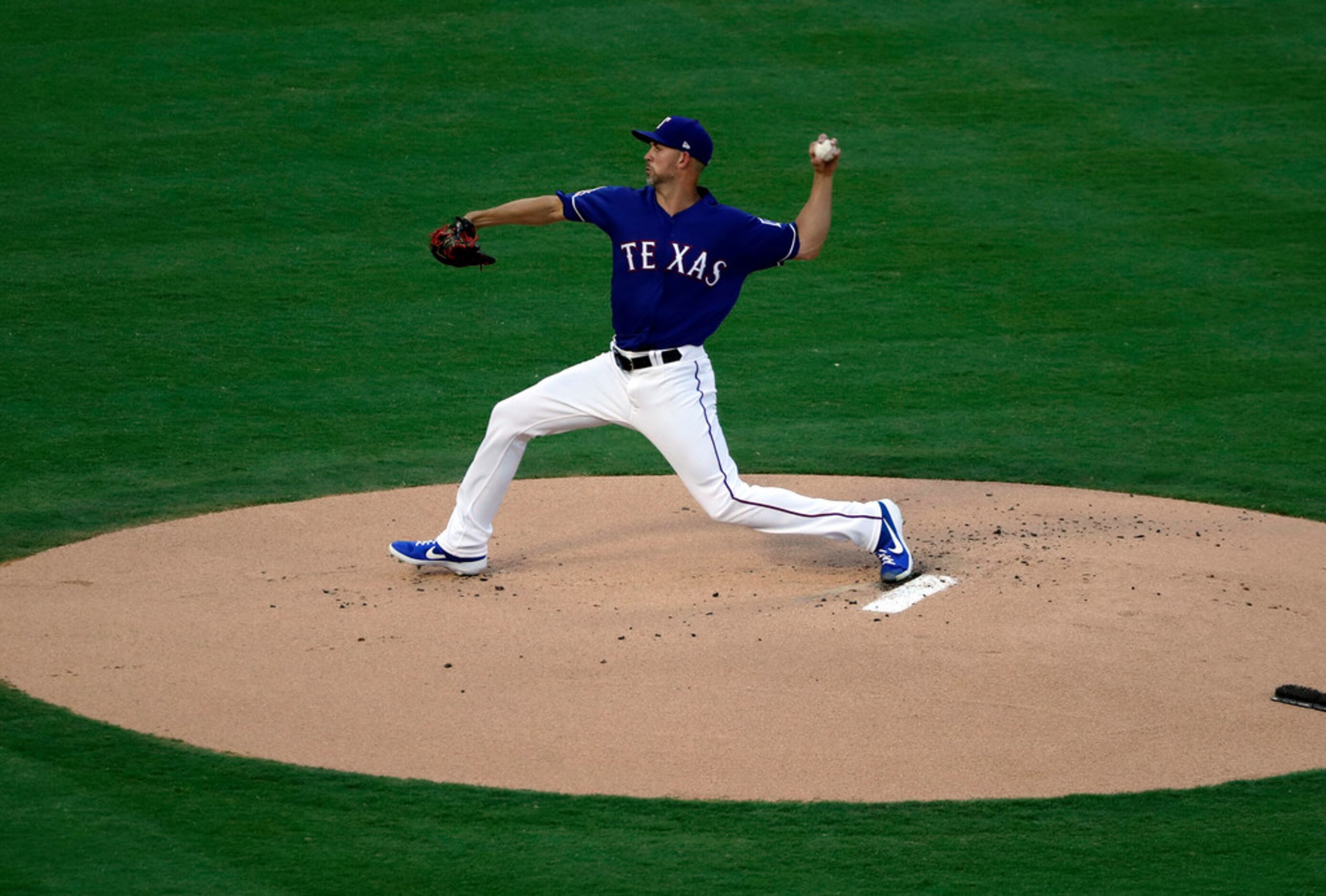 Texas Rangers starting pitcher Mike Minor throws against the Oakland Athletics in the first...