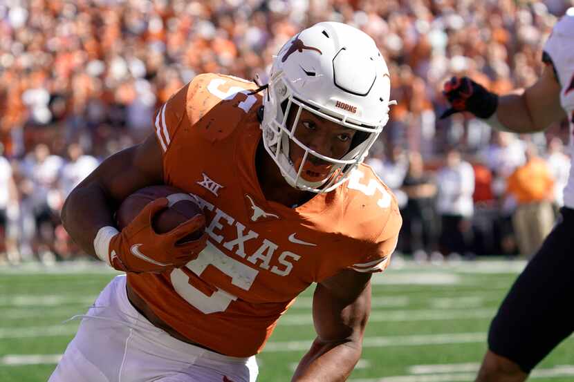FILE - Texas running back Bijan Robinson (5) runs against Oklahoma State during the first...