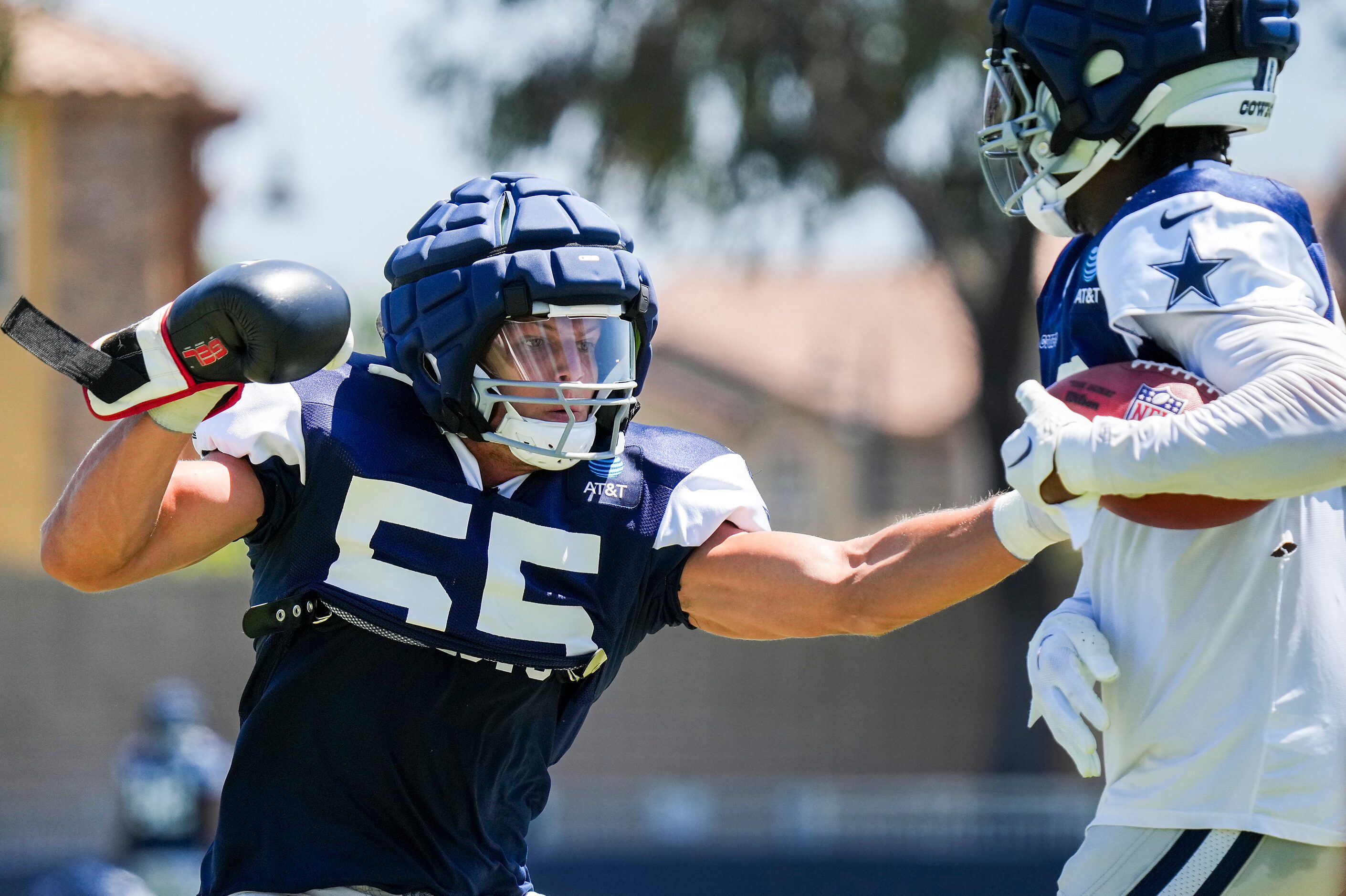 Dallas Cowboys linebacker Micah Parsons (11) tries to punch the ball away from linebacker...