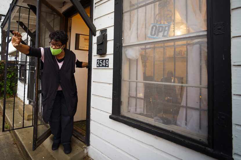 Earnestine Tarrant waves goodbye to a client.