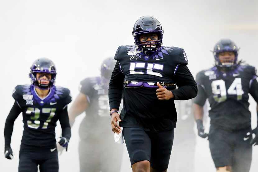 TCU Horned Frogs center Kellton Hollins (55) and the rest of his teammates run onto the...