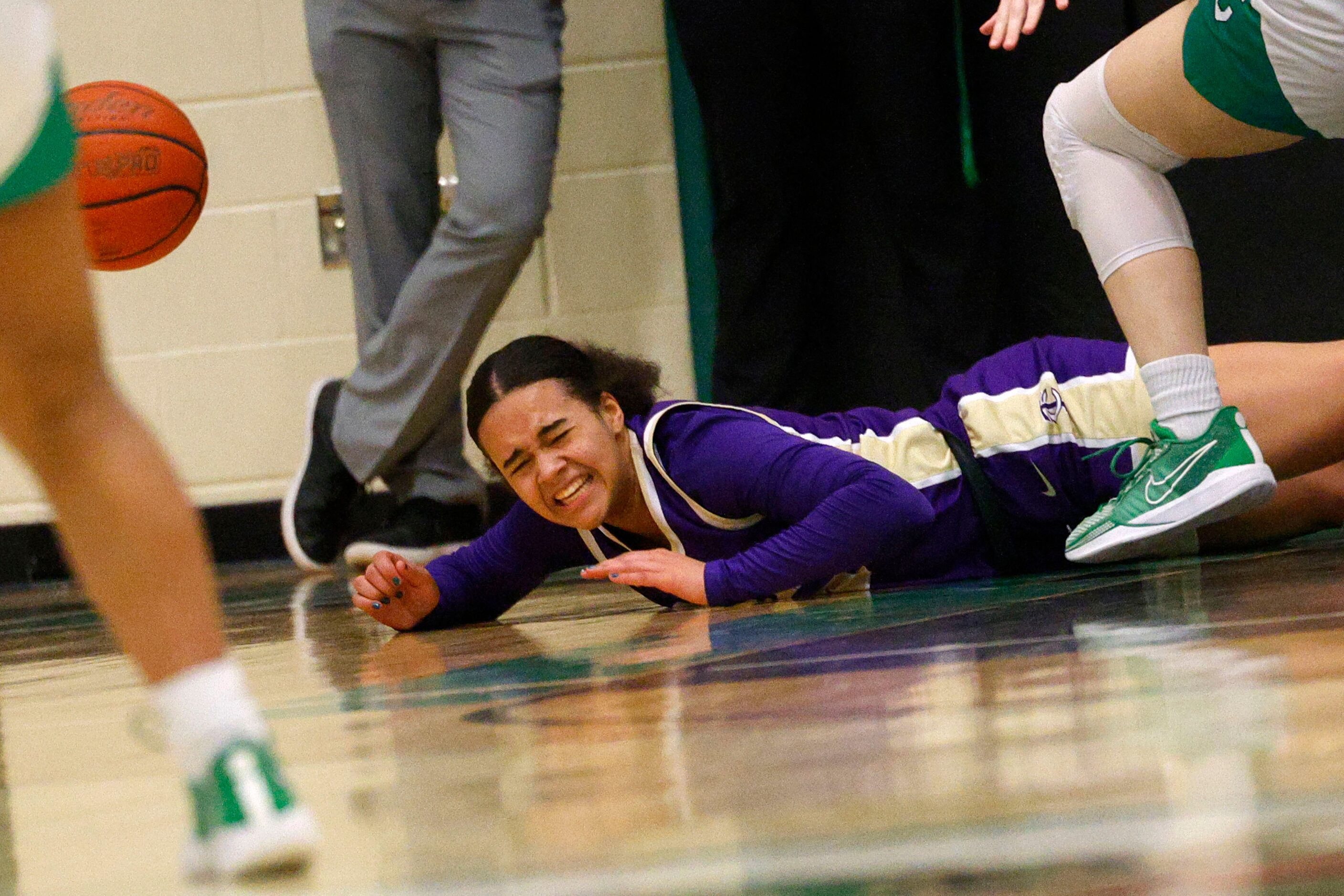 Keller Timber Creek's Kylee Hunt (30) falls to the floor during the first half of a high...