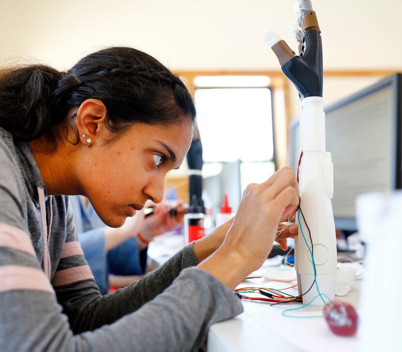 Girl Scout Esha Patel, a sophomore at Harmony Science Academy in Carrollton, assembles...