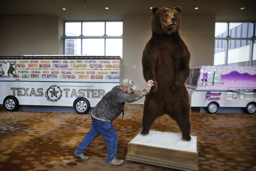 Caleb Townley of Conroe Taxidermy rolled a mounted Kamchatka brown bear through the Omni...