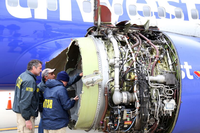 In this National Transportation Safety Board photo, NTSB investigators examine damage to...