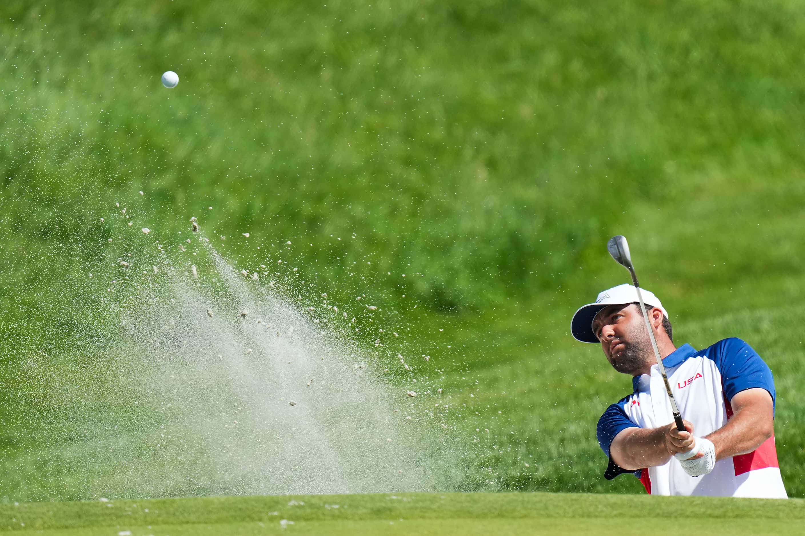 Gold medalist Scottie Scheffler of the United States hits from a greenside bunker during the...