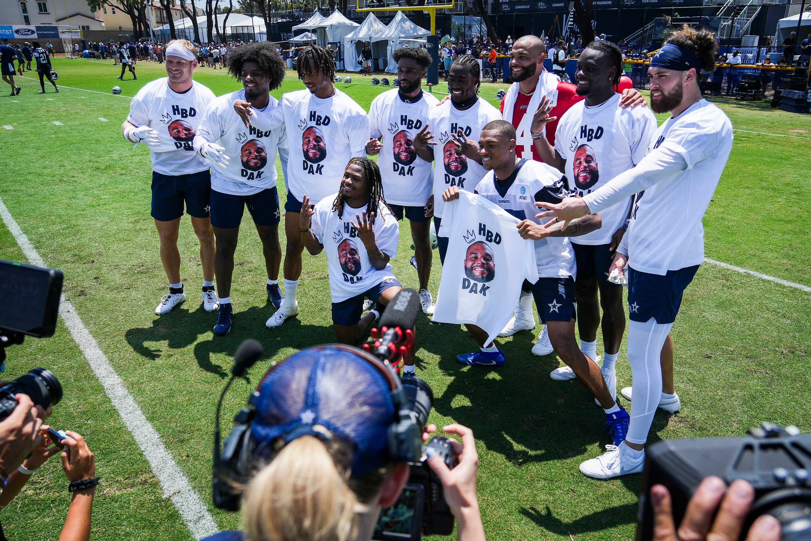 Dallas Cowboys receivers pose for a group photo with quarterback Dak Prescott (4) wearing...