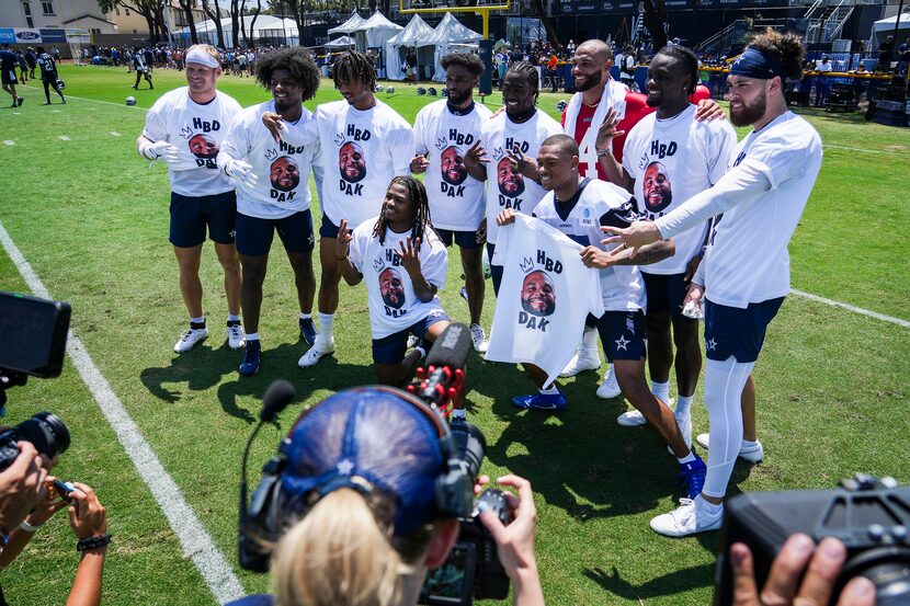 Dallas Cowboys receivers pose for a group photo with quarterback Dak Prescott (4) wearing...