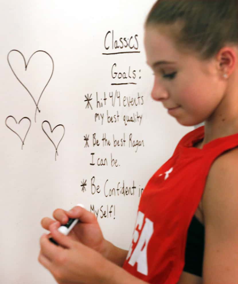 Gymnast Ragan Smith writes down gdaily goals on a whiteboard wall in her room at her home in...