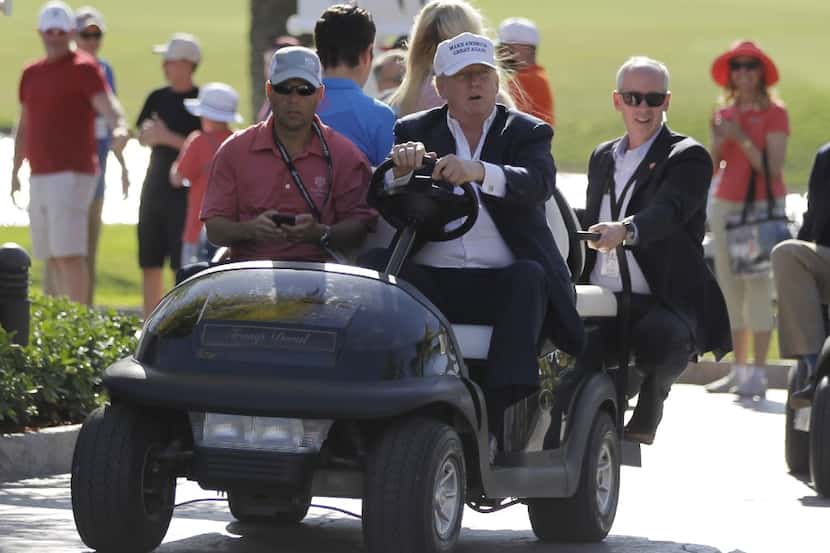 FILE- In this March 6, 2016 file photo, Donald Trump drives himself around the golf course...