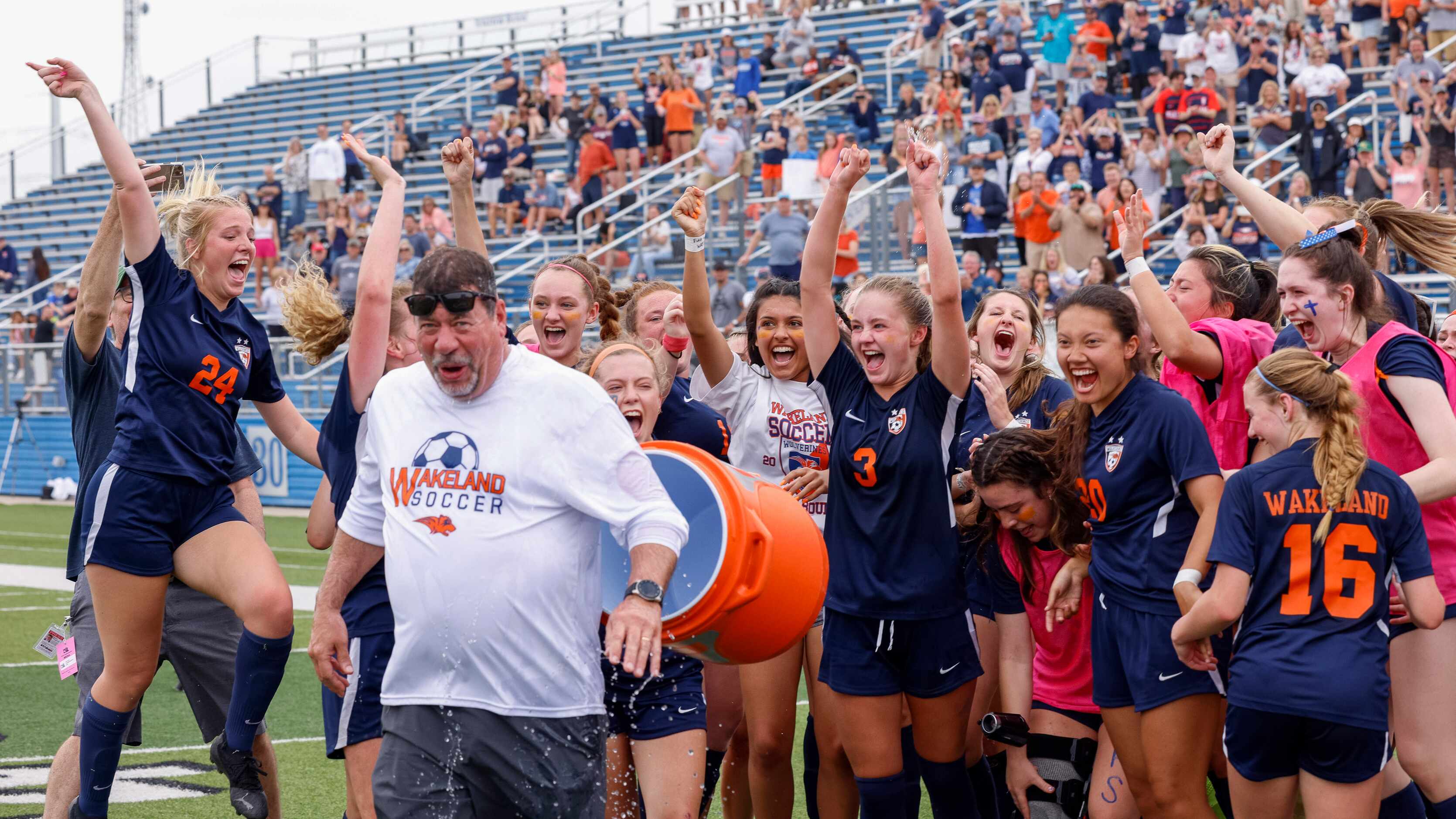 Frisco Wakeland players dunk a cooler of water on Frisco Wakeland head coach Jimmie Lankford...