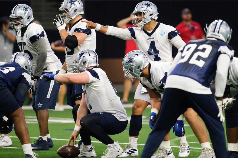 Dallas Cowboys quarterback Dak Prescott (4) lines up behind center Adam Redmond (61) during...