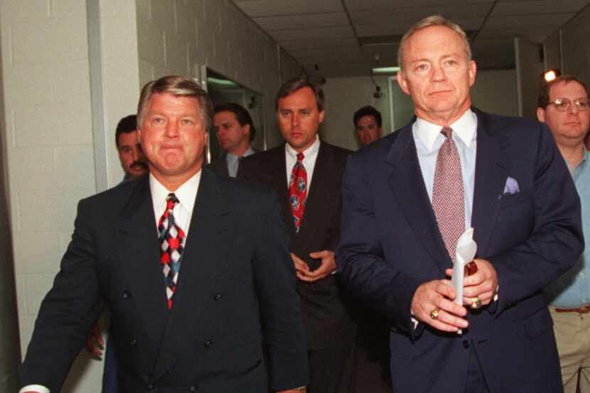 ORG XMIT:  3-29-94.. Jimmy Johnson (L), with a concern look on his  face walks past the...
