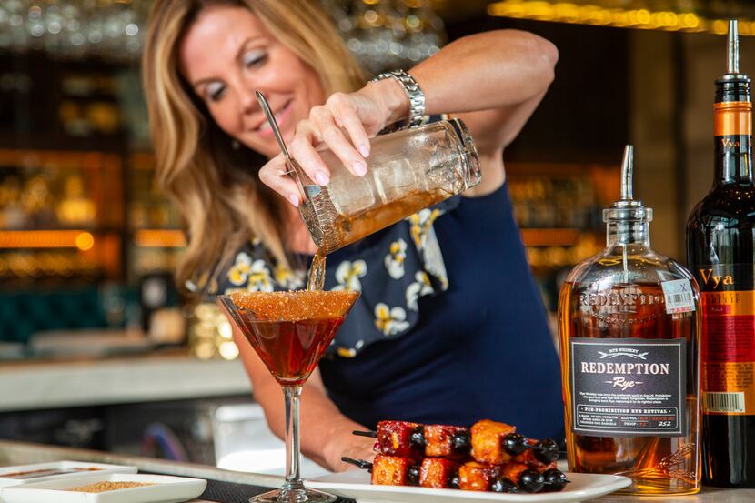 Perry's Hog-Hattan is a spicy Manhattan topped with pork chop bites and Luxardo cherries....