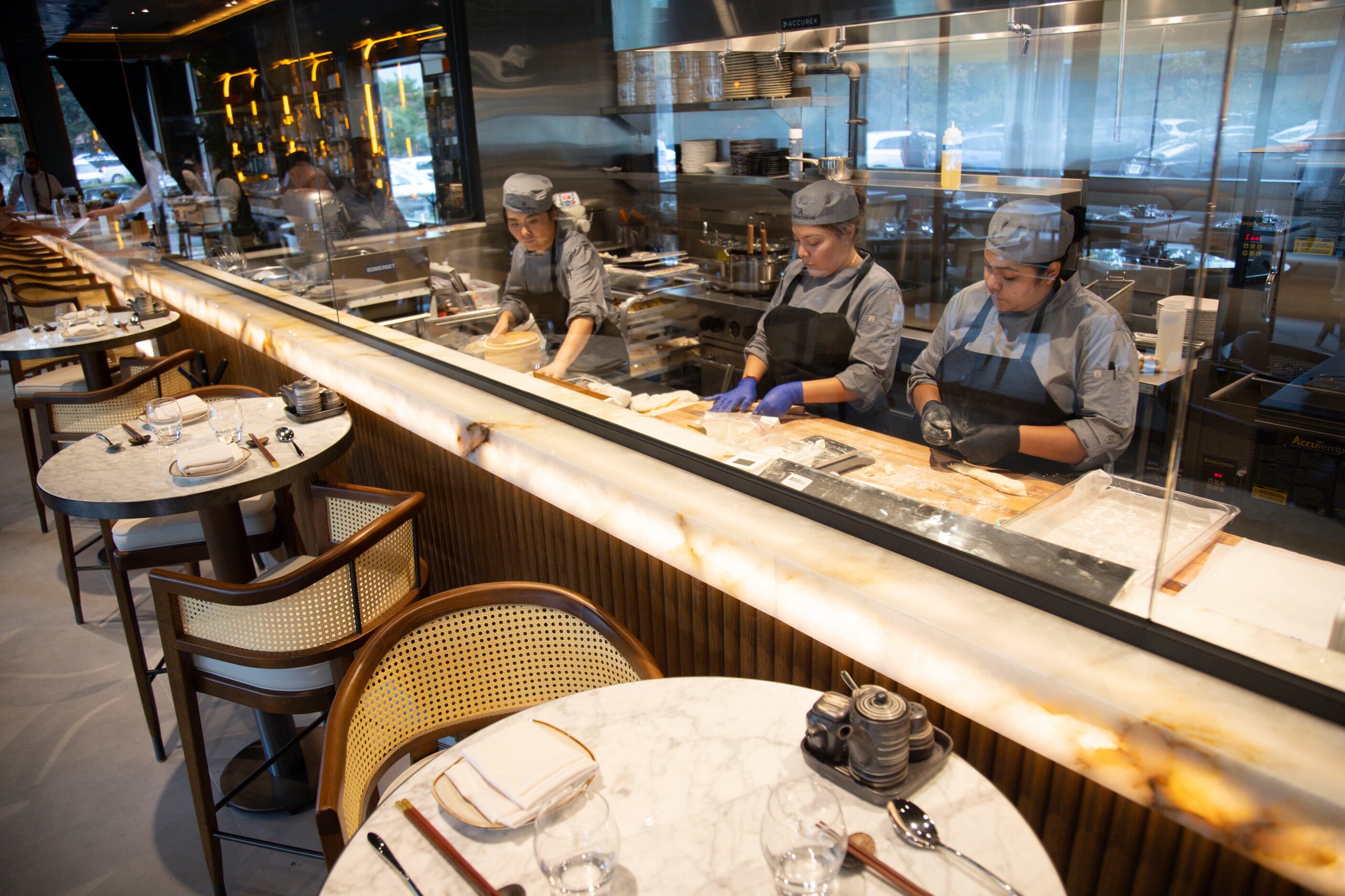 (From left) Dim sum chef Jinyi Lee, dumpling chefs Diana Pacheco and Yasmin Aguilar prepare...