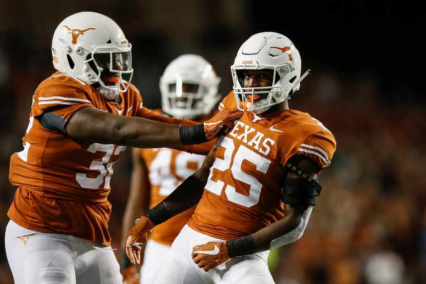 AUSTIN, TX - NOVEMBER 17:  Malcolm Roach #32 of the Texas Longhorns congratulates B.J....