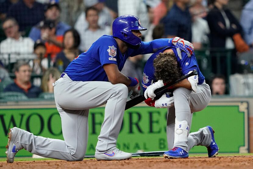 Chicago Cubs' Albert Almora Jr., right, is comforted by Jason Heyward after hitting a foul...