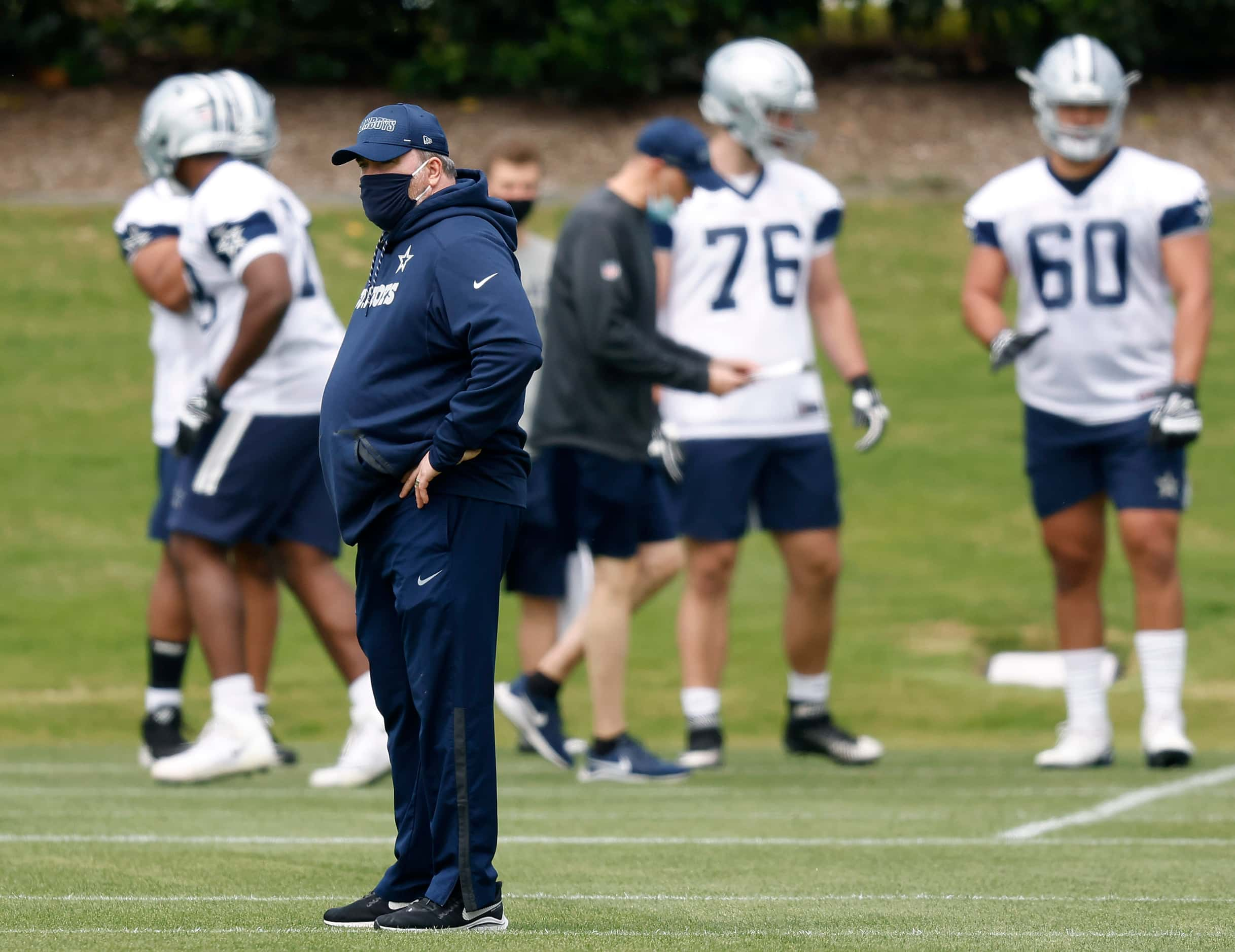 Dallas Cowboys head coach Mike McCarthy watches his rookies go through minicamp at The Star...