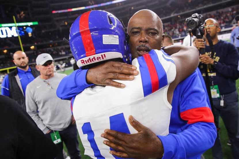 Duncanville's coach Reginald Samples consoles quarterback Chris Parson (14) after losing a...