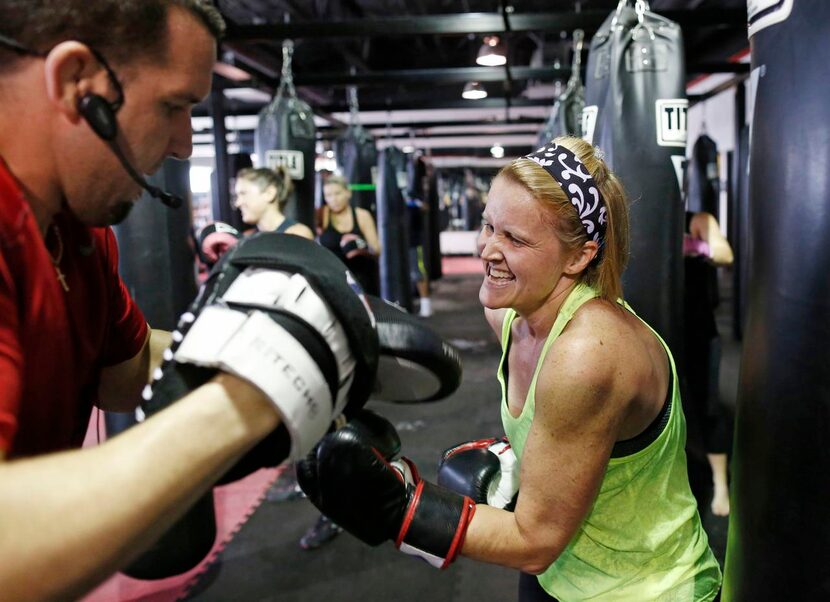 Boxing instructor Sean Holden  spars with Robin Malone of McKinney during a workout at Title...