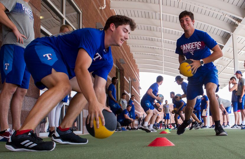 Texas Rangers' pitcher Cole Winn (left) gets the upper hand on Owen White(right) while...