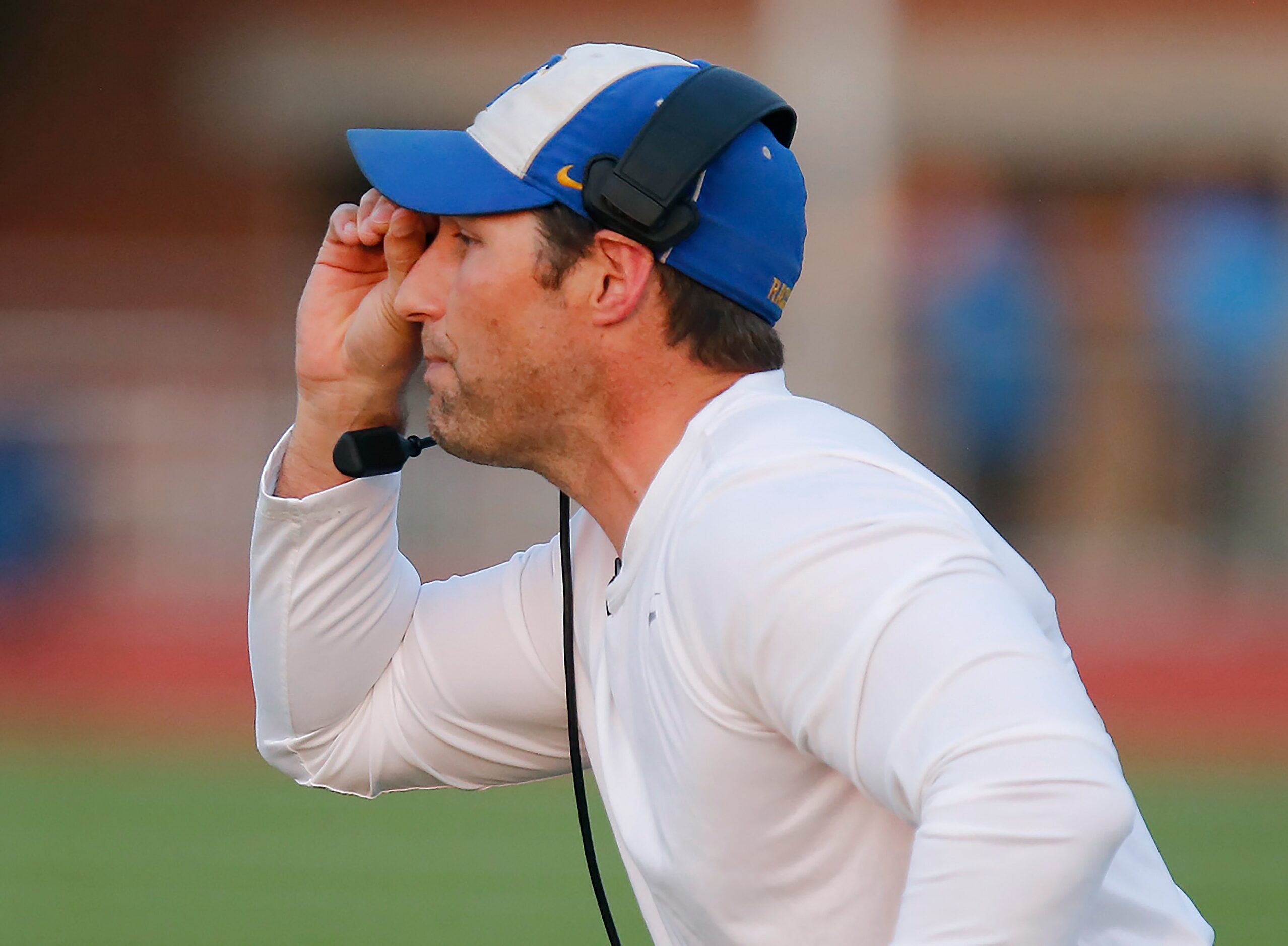 Frisco High School head coach Jeff Harbert sends messages to his team during the first half...