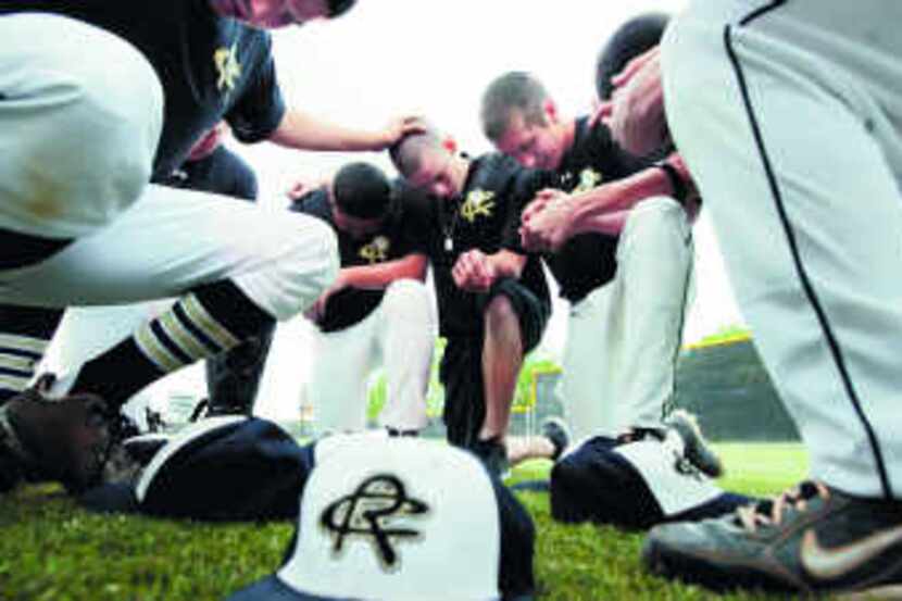  Surrounded by Royse City teammates, Jake Owen led a prayer before a recent game against...