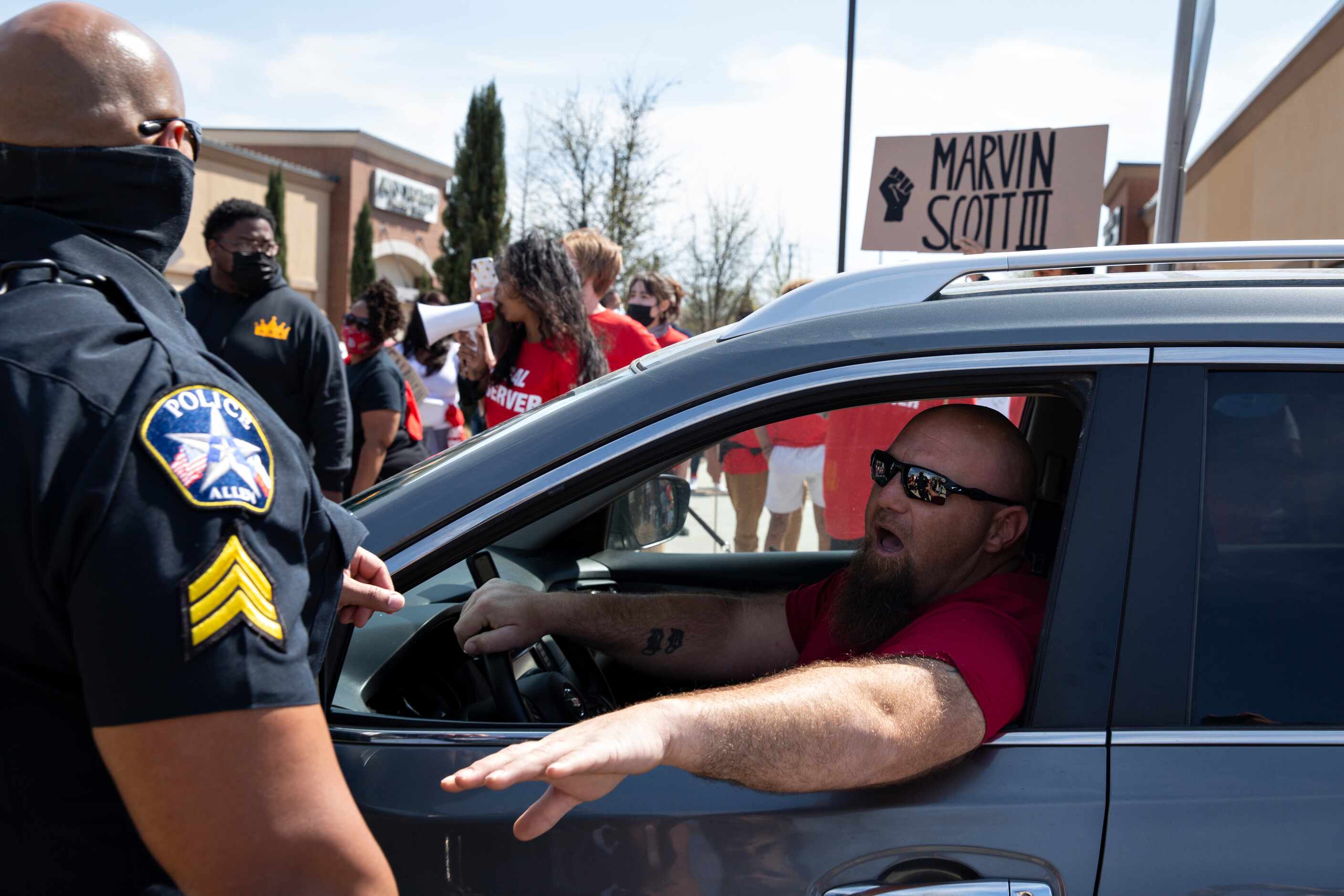 A driver gets frustrated with the traffic caused by a march through the Allen Outlets on...