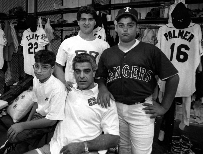 Zack Minasian, center, sits with  his sons Calvin, left, Rudy, center, and Perry, right, in...