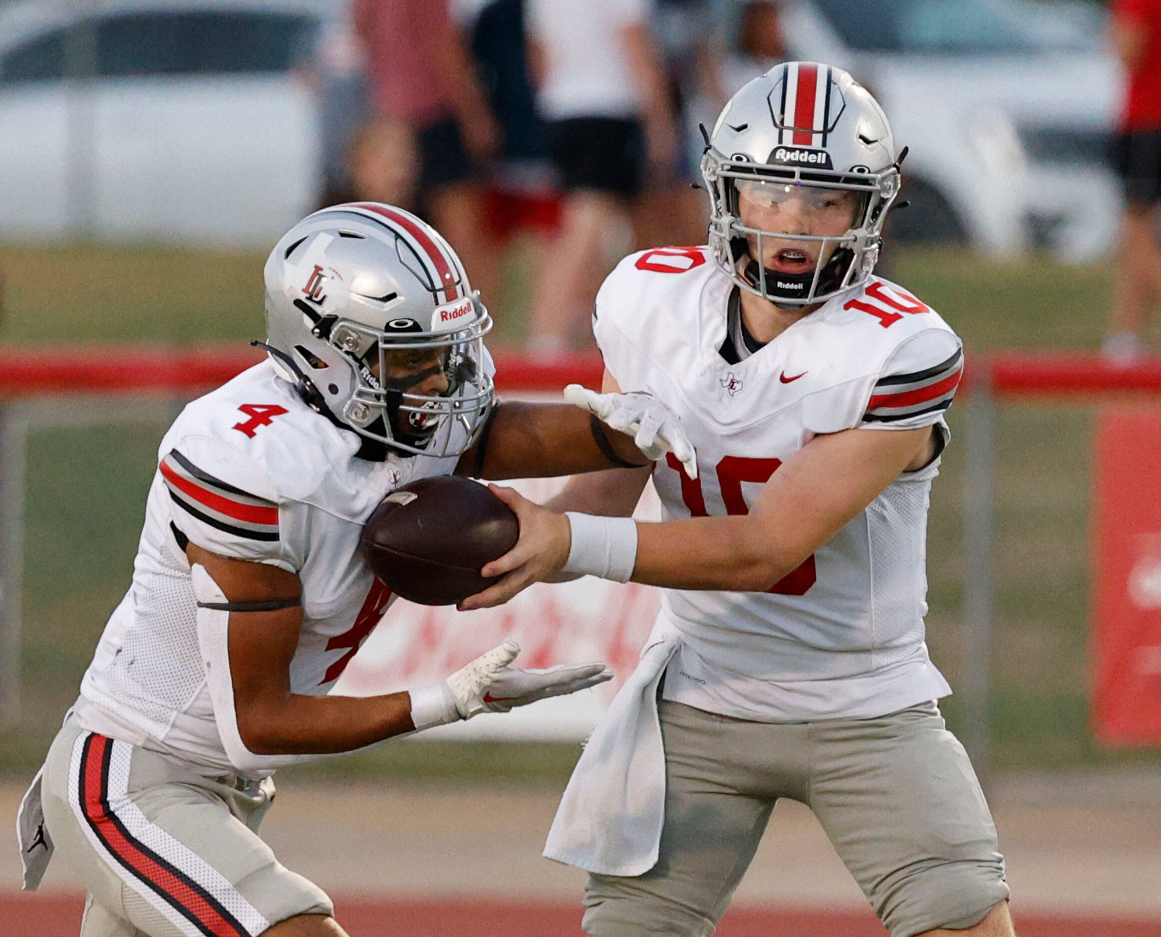 Lovejoy's quarterback Alexander Flanklin (10) hands off to Lovejoy's Dante Dean (4) during...