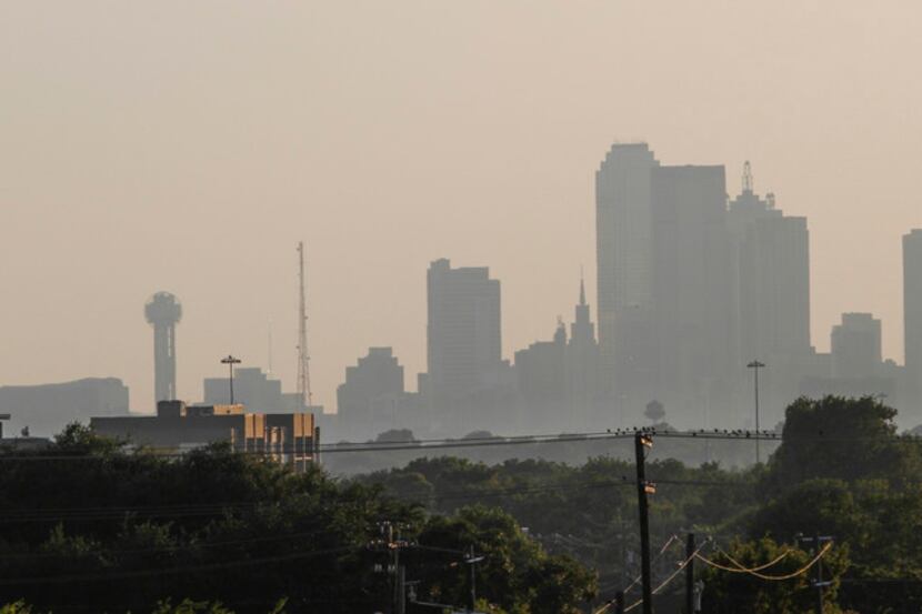 Smog over the Dallas skyline in 2019. Ozone, one component of smog, may be rising partially...