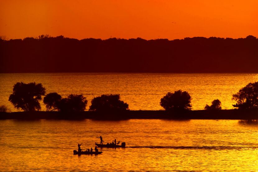 Fisherman on Lake Texoma cast their lines at sunset, Saturday July 21, 2012. With warning...