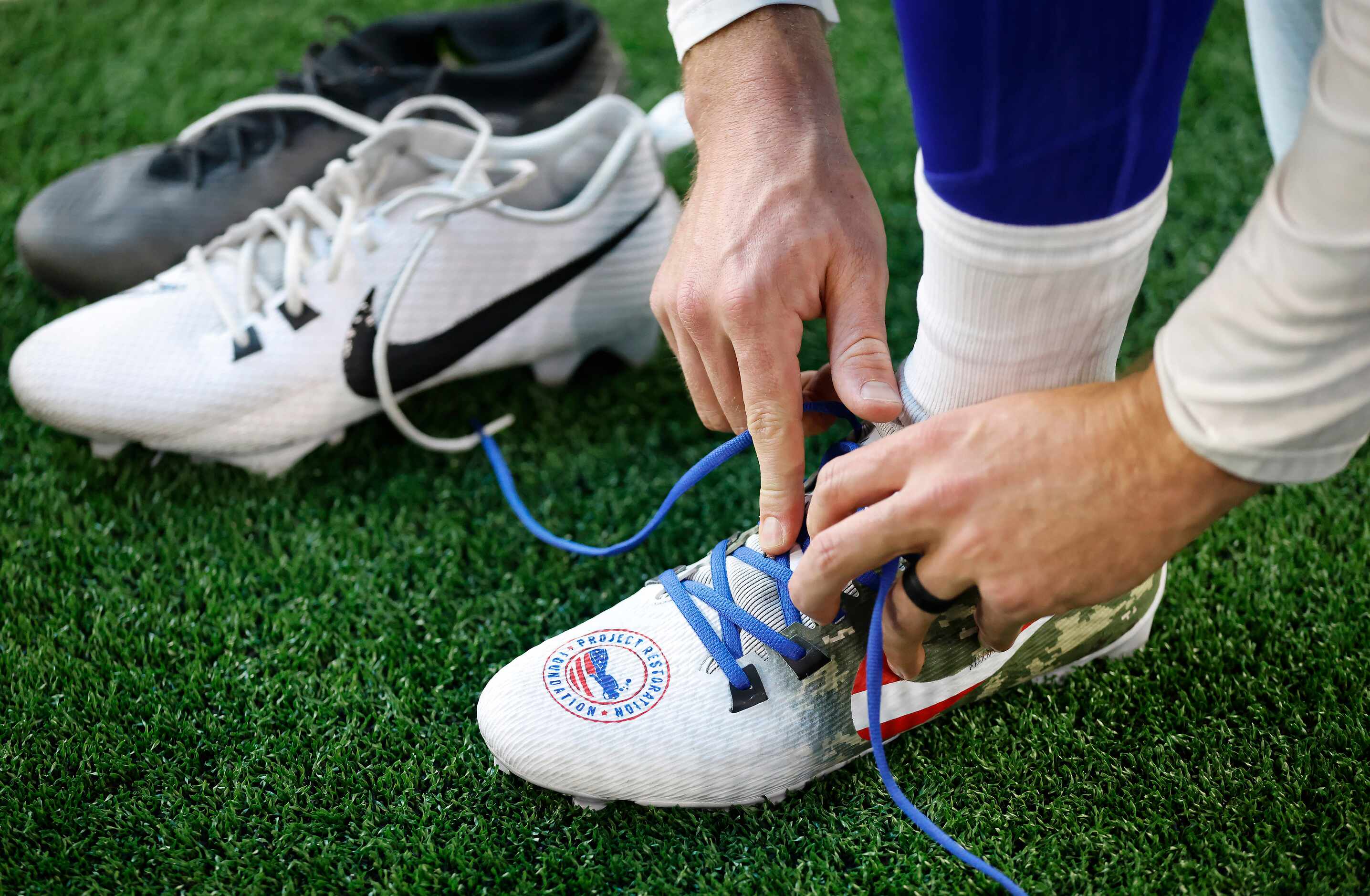 Dallas Cowboys punter Bryan Anger changes out of his custom shoes My Cause My Cleats...