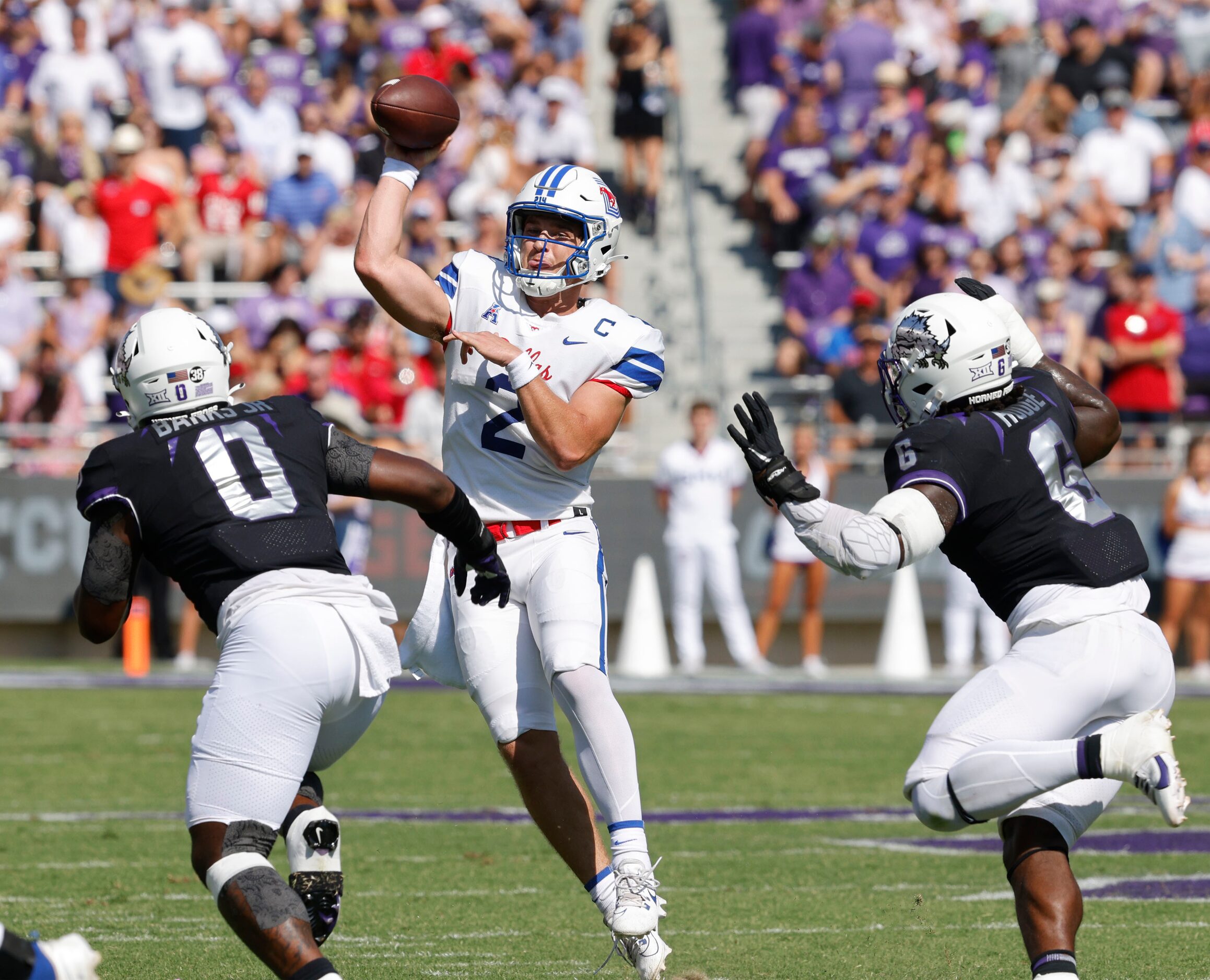 Southern Methodist Mustangs quarterback Preston Stone (2) passes under pressure from TCU...