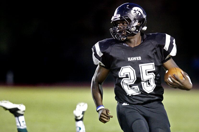Cistercian running back Dare Odeyingbo (25) looks for more running room after a long run...