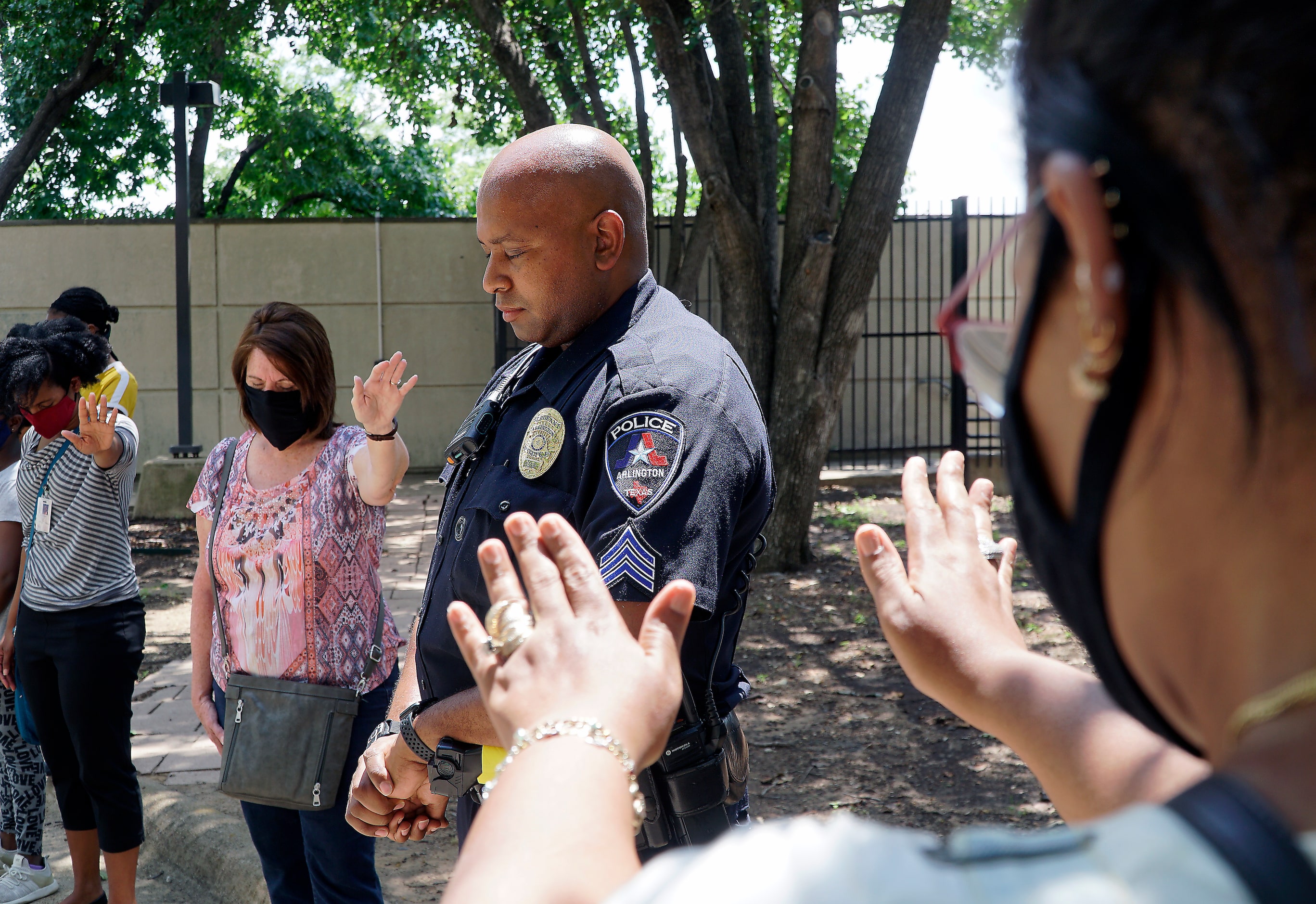 Sgt. Jeremy Lee was among several officers at a prayer for peace at police headquarters in...