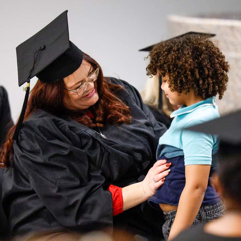 Graduate Amanda Steggall smiles after hugging her son Christopher Stephenson, 6, after...