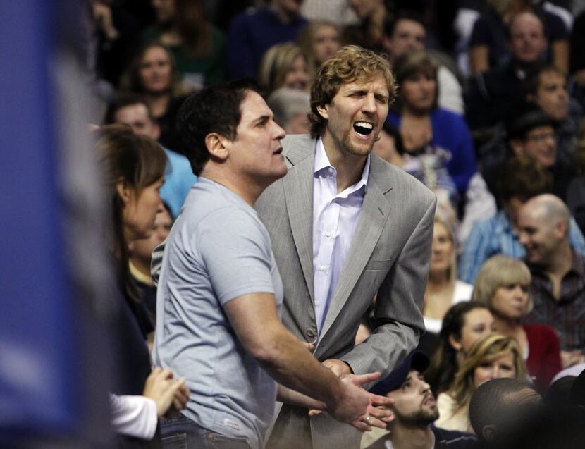 Dallas Mavericks power forward Dirk Nowitzki (41) and owner Mark Cuban react to a call in...