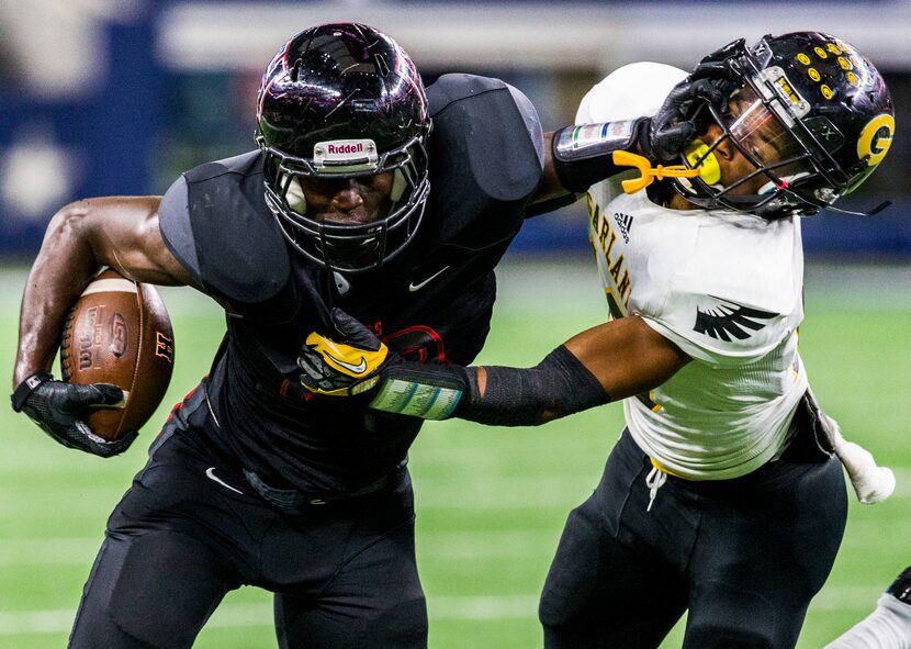 Garland defensive back Josh Thompson (10) gets pushed away as he tackles Rockwall-Heath's...