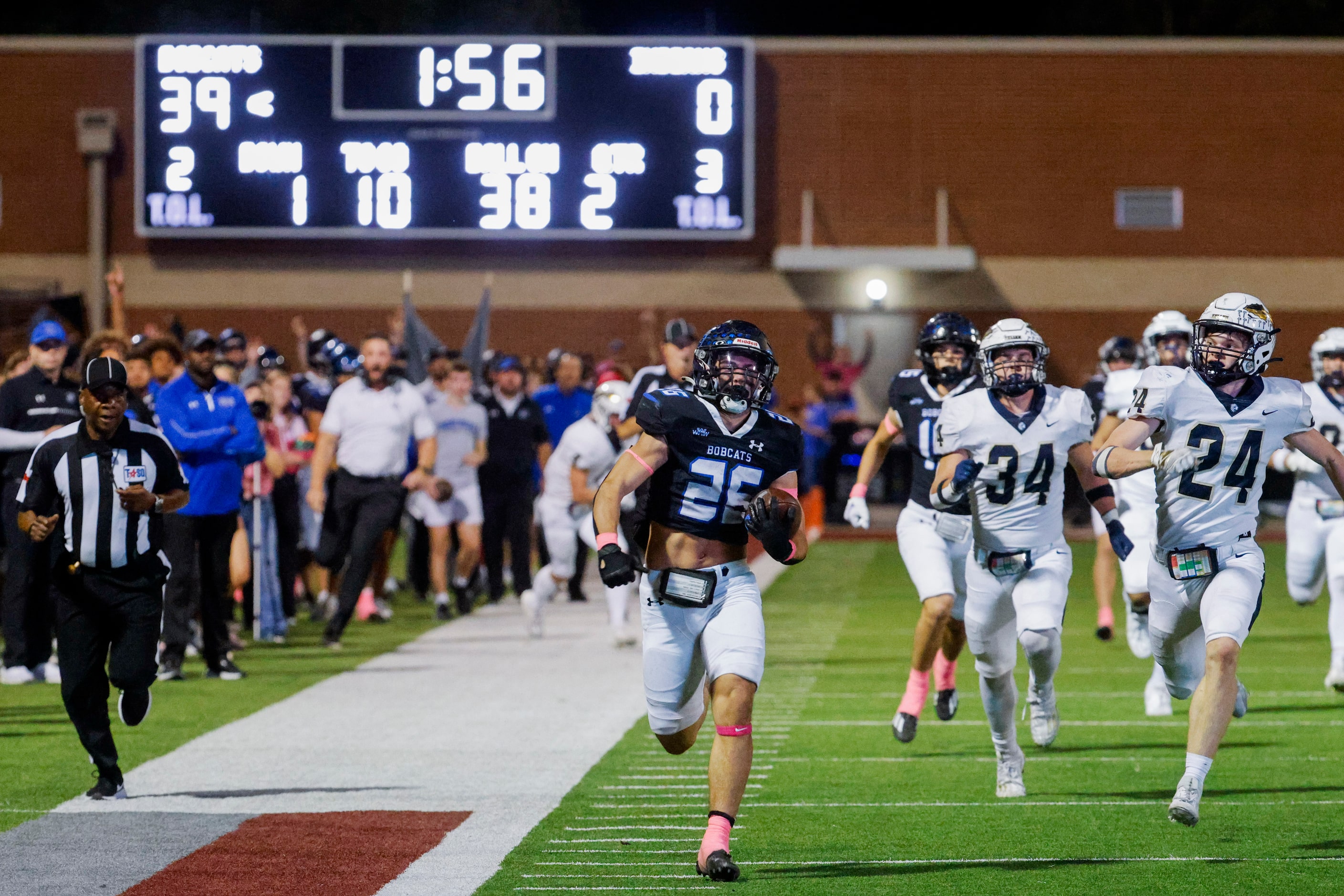 Byron Nelson’s Tucker James (26) runs past Keller high players as he scores a touchdown...