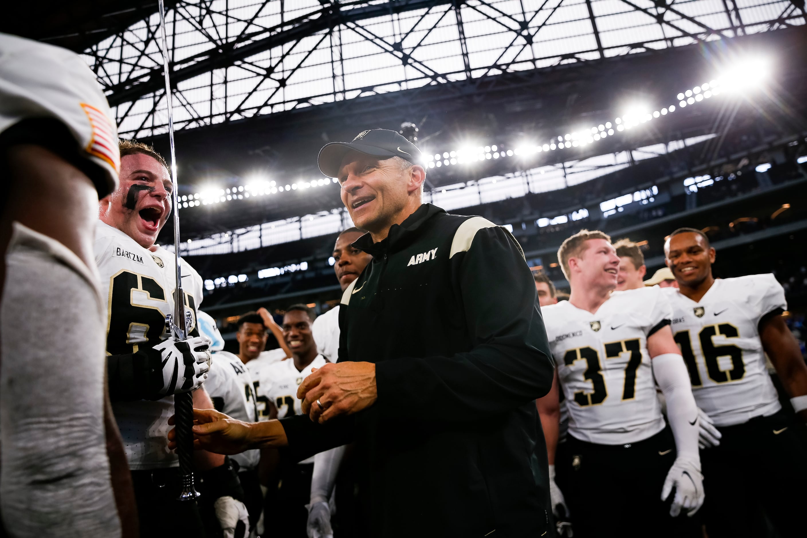 Army Black Knights head coach Jeff Monken celebrates with players after winning during...
