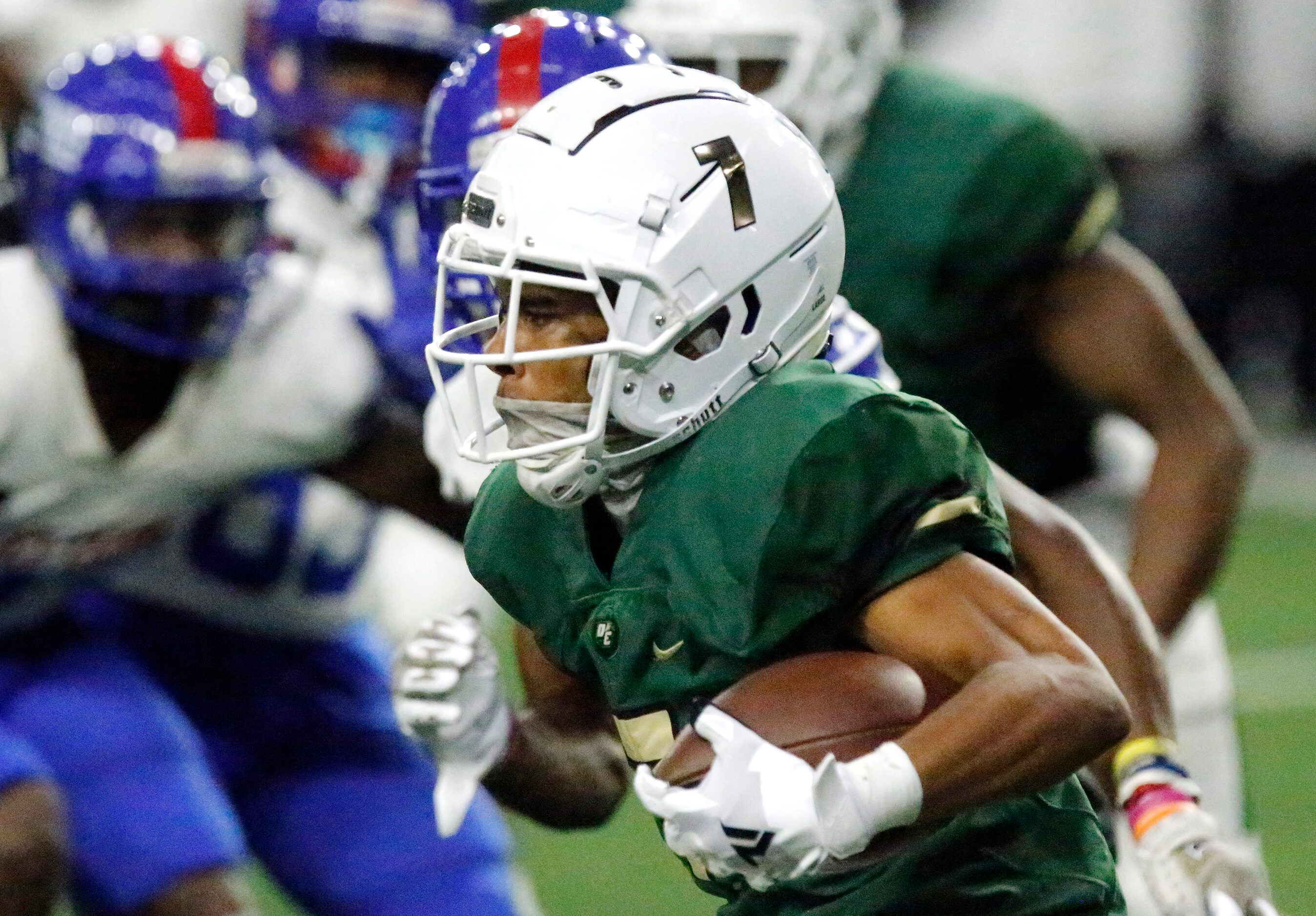 DeSoto High School kick returner Kam’ron Singleton (7) gets a return during the first half...