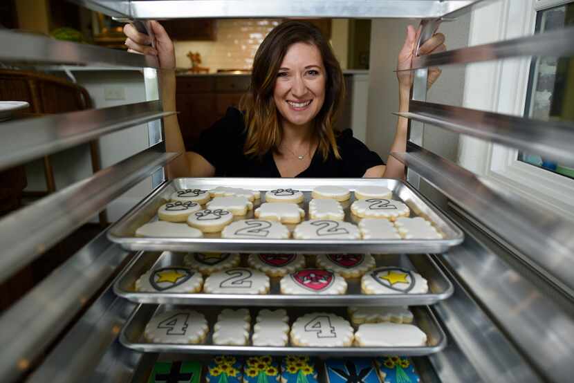 Cale Pruit of Tesoro Baking Co. with several trays of cookies she baked and decorated at her...